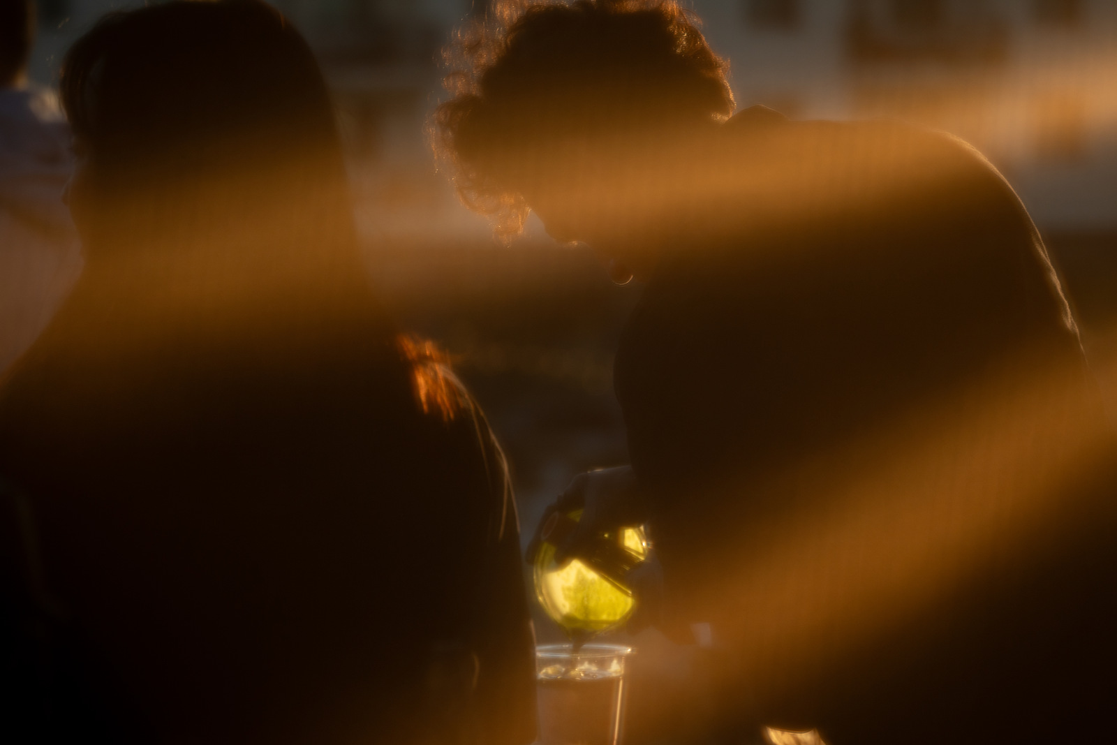 Customers gathered at the Iro Tea booth in golden-hour light, glasses in hand