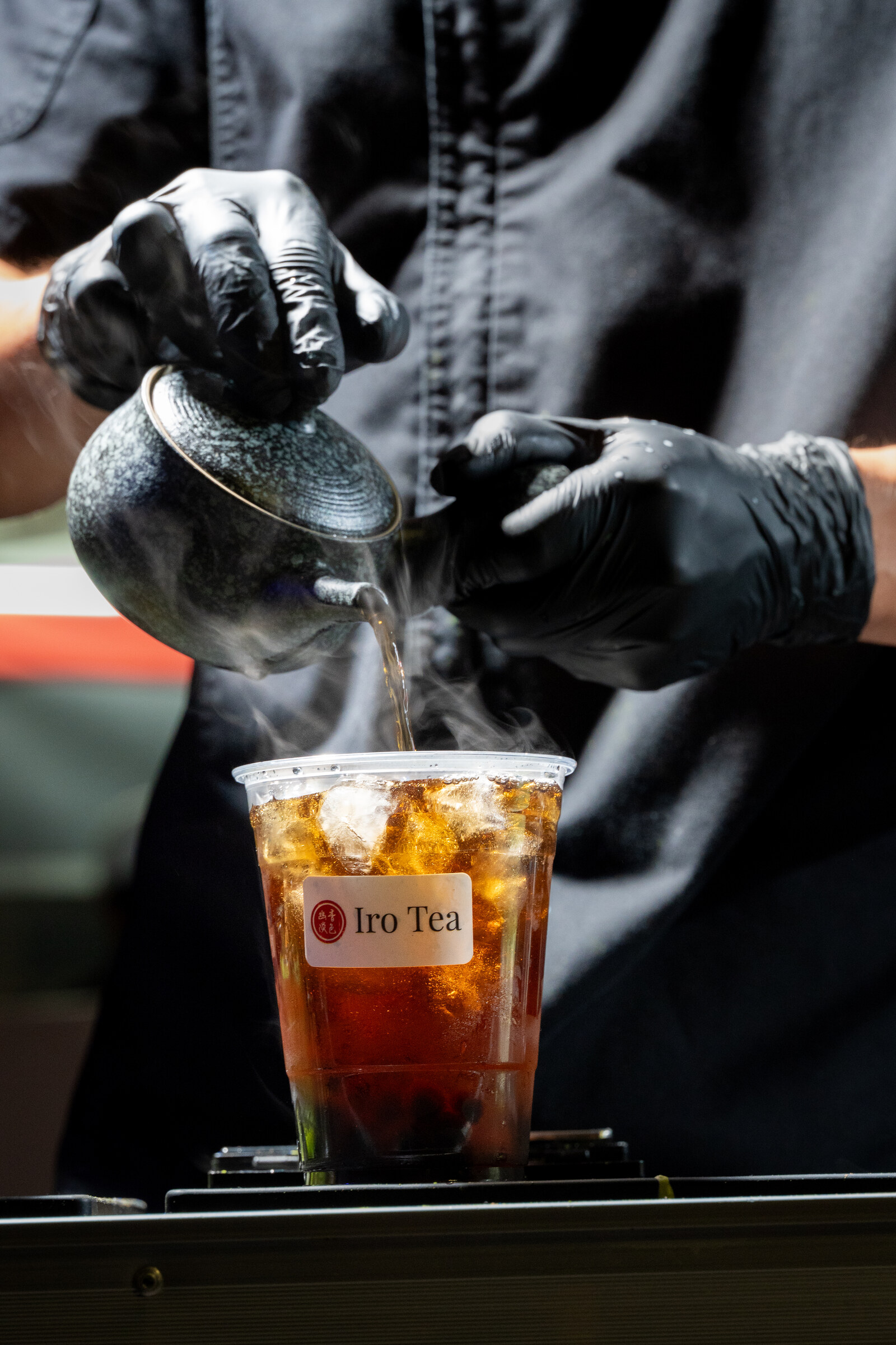 Dark oolong being poured over ice